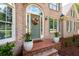 Home's inviting entryway with a decorative wreath and potted plants at 101 Misty Valley Dr, Canton, GA 30114
