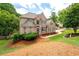 A two-story brick home with a well-manicured lawn and mature trees around the property at 101 Misty Valley Dr, Canton, GA 30114