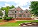 Charming two-story brick home with manicured lawn and mature landscaping at 101 Misty Valley Dr, Canton, GA 30114