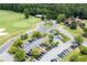 Golf course with putting green, clubhouse, and parking lot in a well-maintained community at 101 Misty Valley Dr, Canton, GA 30114