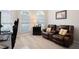 The carpeted living room includes a comfortable brown loveseat with two large sunny windows at 101 Misty Valley Dr, Canton, GA 30114