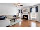 Cozy living room with hardwood floors, fireplace, and comfortable seating at 101 Misty Valley Dr, Canton, GA 30114