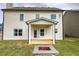 Covered patio in the backyard with a cozy fire pit for outdoor enjoyment at 200 Eva Way Ne, Cartersville, GA 30121