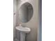 Powder room featuring pedestal sink and decorative oval mirror at 200 Eva Way Ne, Cartersville, GA 30121