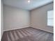 Bright bedroom features neutral walls, soft carpet, and natural light from the window at 200 Eva Way Ne, Cartersville, GA 30121