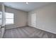 Well-lit bedroom with plush carpet, a window with blinds, and a white interior door at 200 Eva Way Ne, Cartersville, GA 30121