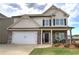 Charming two-story home with stone accents, covered porch, two-car garage, and manicured front yard at 200 Eva Way Ne, Cartersville, GA 30121