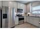 Well-lit kitchen with stainless steel appliances, granite countertops, and white cabinets at 200 Eva Way Ne, Cartersville, GA 30121