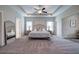 Spacious main bedroom with tray ceiling, ceiling fan, carpet and a large mirror at 200 Eva Way Ne, Cartersville, GA 30121