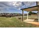 Covered patio overlooking a well-maintained backyard with a modern fire pit at 200 Eva Way Ne, Cartersville, GA 30121