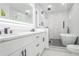 A renovated bathroom with double vanity, a glass enclosed shower and a free standing tub at 262 Crumley St Sw, Atlanta, GA 30312