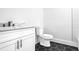 Modern bathroom with hexagon tile floor, quartz countertop, and white cabinets at 262 Crumley St Sw, Atlanta, GA 30312