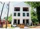 Modern two-story home with white brick, black framed windows, and second story balconies at 262 Crumley St Sw, Atlanta, GA 30312