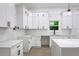 A modern kitchen with white cabinets, quartz countertops, and stainless steel appliances at 262 Crumley St Sw, Atlanta, GA 30312