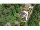 Aerial view of a home in lush wooded area, with landscaped yard and circular driveway at 2682 Boulder Creek Ne Dr, Roswell, GA 30075