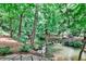 Scenic creek meanders through the wooded backyard, creating a tranquil natural setting at 2682 Boulder Creek Ne Dr, Roswell, GA 30075