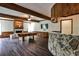 Spacious basement featuring a stone bar, pool table, hardwood floors, and a cozy fireplace at 2682 Boulder Creek Ne Dr, Roswell, GA 30075
