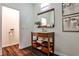 Charming powder room featuring wood vanity with open shelving and modern fixtures at 2682 Boulder Creek Ne Dr, Roswell, GA 30075