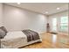 Bright bedroom featuring hardwood floors, light walls, and access to the outdoor balcony at 2682 Boulder Creek Ne Dr, Roswell, GA 30075