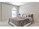 Bedroom with a neutral color scheme, soft carpet, and a large window for natural light at 2682 Boulder Creek Ne Dr, Roswell, GA 30075