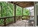Cozy covered deck with wooden railings and relaxing views of the surrounding greenery at 2682 Boulder Creek Ne Dr, Roswell, GA 30075
