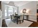 Bright dining room featuring a modern chandelier, large windows, and views to the backyard at 2682 Boulder Creek Ne Dr, Roswell, GA 30075