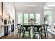 Spacious dining room featuring French doors, a modern light fixture, and a view of the backyard at 2682 Boulder Creek Ne Dr, Roswell, GA 30075