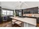 Modern kitchen features a large island, stainless steel appliances, and a wine refrigerator at 2682 Boulder Creek Ne Dr, Roswell, GA 30075