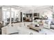 Spacious open-concept living room with stylish furniture that flows seamlessly into the adjacent kitchen and dining areas at 2682 Boulder Creek Ne Dr, Roswell, GA 30075
