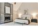 This contemporary main bedroom features a modern fireplace, neutral tones, and plush carpeting for a comfortable retreat at 2682 Boulder Creek Ne Dr, Roswell, GA 30075