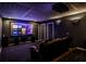 Home theater with a large screen, projector, comfortable seating, and dark ambiance at 2682 Boulder Creek Ne Dr, Roswell, GA 30075