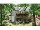 Multi-level decks and a hot tub enhance this home's serene backyard oasis with mature trees and landscaping at 2682 Boulder Creek Ne Dr, Roswell, GA 30075