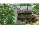 This home boasts tiered wooden decks and outdoor hot tub surrounded by mature trees offering serene backyard oasis at 2682 Boulder Creek Ne Dr, Roswell, GA 30075