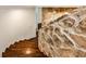 Hardwood staircase with a unique stone wall accent, providing a rustic yet modern look at 2682 Boulder Creek Ne Dr, Roswell, GA 30075