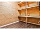 Basement storage area with wooden shelving, perfect for organization and maximizing space at 2682 Boulder Creek Ne Dr, Roswell, GA 30075