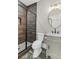 Elegant bathroom featuring a glass shower with wood-look tile, a stylish vanity, and modern fixtures at 407 Estates View Dr, Acworth, GA 30101