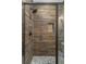 Walk-in shower features decorative tile and bronze fixtures in this modern bathroom at 407 Estates View Dr, Acworth, GA 30101