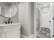 Modern bathroom features a custom vanity and a sleek mirror with a walk-in shower at 407 Estates View Dr, Acworth, GA 30101