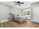 Bright bedroom features a ceiling fan, wood floors, and a large window with natural light at 407 Estates View Dr, Acworth, GA 30101
