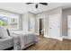 Light-filled bedroom boasts hardwood floors, ample closet space, and access to a modern bathroom at 407 Estates View Dr, Acworth, GA 30101