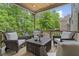 Covered deck with outdoor seating area and forest view at 407 Estates View Dr, Acworth, GA 30101