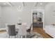 Dining area with views to the kitchen; features a white table and gray upholstered chairs at 407 Estates View Dr, Acworth, GA 30101