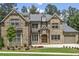 Beautiful brick home featuring a manicured lawn and attached two car garage at 407 Estates View Dr, Acworth, GA 30101