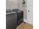 Well-lit laundry room featuring side-by-side washer and dryer in a neutral color scheme at 407 Estates View Dr, Acworth, GA 30101