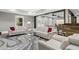 Basement living room featuring neutral furniture, glass tables, and access to outdoors at 407 Estates View Dr, Acworth, GA 30101