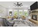 Bright living room with a stone fireplace, large windows, and hardwood flooring at 407 Estates View Dr, Acworth, GA 30101