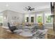 Spacious living room with large windows, a gray sofa, and modern decor at 407 Estates View Dr, Acworth, GA 30101