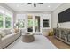 Living room featuring an abundance of natural light and hardwood flooring with a door to the back porch at 407 Estates View Dr, Acworth, GA 30101