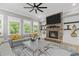 Comfortable living room with a stone fireplace, gray sofa, and bright natural light at 407 Estates View Dr, Acworth, GA 30101