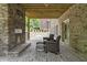 Spacious covered patio with a stone fireplace and ample seating arrangement at 407 Estates View Dr, Acworth, GA 30101